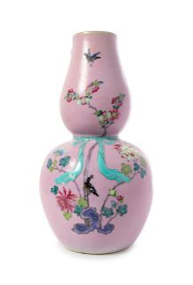 A Pink Ground Famille Rose Gourd-Form Vase
Height 16 1/2 in., 42 cm. 
