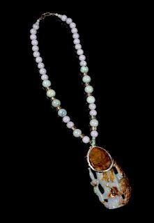 A Jadeite Beaded Necklace
Length 19 1/4 in., 49 cm. 
