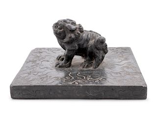 A Large Carved Black Stone Weight
Length 9 1/2 in., 24 cm. 