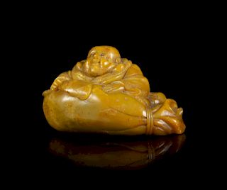 A Carved Soapstone Figure of a Laughing Buddha
Length 4 in., 10 cm. 