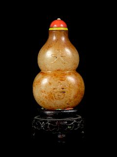 A Russet and Celadon Jade Double-Gourd Form Snuff Bottle
Height 2 1/2 in., 6 cm. 