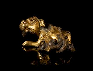 A Gilt Bronze Mythical Beast-Form Paper Weight
Length 3 3/4 in., 10 cm. 