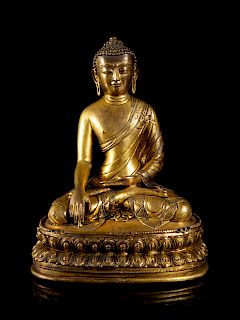 A Sino-Tibetan Gilt Bronze Figure of Buddha
Height 7 5/8 in., 19 cm. 