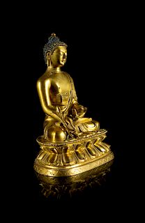 A Sino-Tibetan Gilt Bronze Figure of Sakyamuni Buddha
Height 6 1/2 in., 17 cm. 