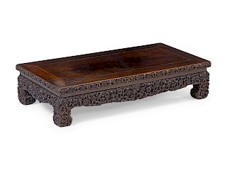 A Carved Hardwood Rectangular Stand
Height 6 x length 26 1/2 x width 13 1/8 in., 15 x 67 x 33 cm.