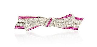 * An Art Deco Platinum, Ruby, Synthetic Ruby and Diamond Bow Brooch, 8.20 dwts.