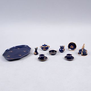 Juego de té miniatura. Francia, siglo XX. Elaborado en porcelana Limoges azul cobalto con filos en esmalte de oro. Piezas: 11