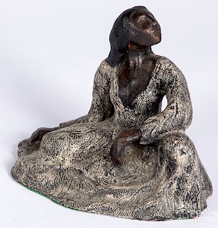 Painted pottery figure of a woman.