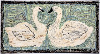Hooked rug of two swans