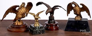 Four brass and metal eagle finials