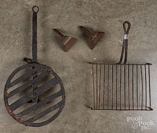 Two wrought iron trivets, etc.