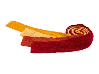 Four Hermes knit ties, one yellow, one red, one orange, one burnt orange.