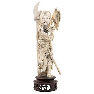 WARRIOR. CHINA, 20TH CENTURY. Carved ivory with black ink details. Includes wooden base.