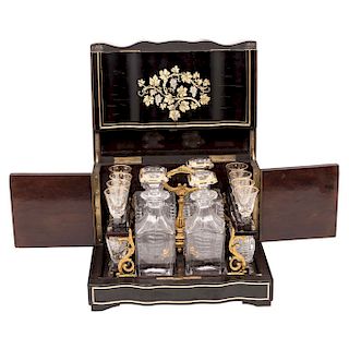 DECANTER BOX. FRANCE, 19TH CENTURY. Napoleon III Style. Ebonized wood with brass details. 4 decanters and 16 crystal glasses. 