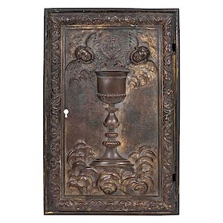 TABERNACLE DOOR. MEXICO, CIRCA 1900. Bronze with a central chalice figure and flanking cherubs, surrounded by a border with arabesques 