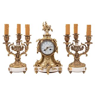 CLOCK AND TWO CANDLESTICKS. FRANCE, 19TH CENTURY. Louis XV Style. Golden bronze with marble. 