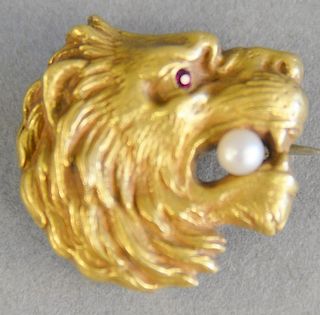 14K gold lion head pin with pearl in mouth and small red stone eye, 4.7 grams.