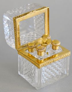 Crystal and gill metal case with four crystal perfumes with gilt metal screw tops and gilt metal funnel, ht. 2 7/8, top:2" x 2 1/4".