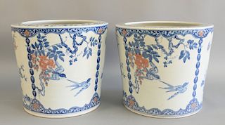 Pair of Chinese underglaze blue and copper red jardinieres painted with birds, butterflies and blossoming plants. ht. 12 3/4 in., di...