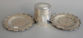 Three piece silver group to include a pair of middle eastern silver circular dishes and a sino tibetan silver biscuit jar of cylindr...