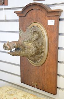 Brass boar head mounted on oak panel. ht. 20 in.