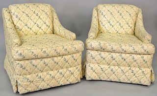 Pair of contemporary upholstered swivelling club chairs.