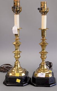 Pair of brass candlesticks made into lamps on ebonized wood bases. total ht. 17 in.