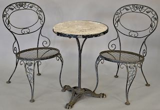 Three piece outdoor ice cream table having round marble top, iron base and two chairs. dia. 20 in., ht. 29 in.