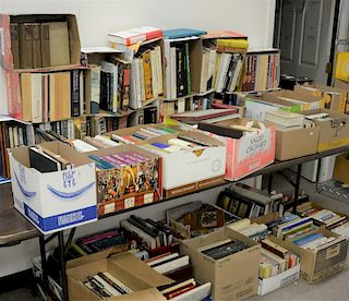 On top and below table of books, approx 40 boxes.
