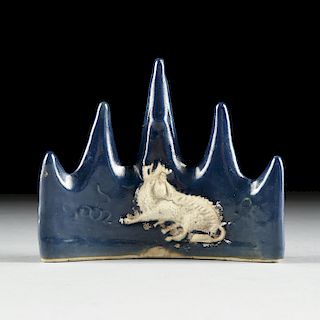 A CHINESE BLUE GLAZE WITH BISCUIT QILIN SCHOLAR'S PORCELAIN BRUSH REST, QING DYNASTY 1644-1912,