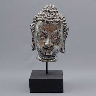 Cabeza del Príncipe Siddharta Gautama (Buda). Origen oriental. SXX. En resina. Con base. Decorada con esmalte plateado. 32 x 21 x 20 cm