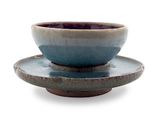 A Chinese Jun-Type Stoneware Cup and Stand
Cup: diam 3 1/2 in., 9 cm. Overall height 2 3/8 in., 6 cm.