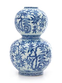 A Chinese Blue and White Gourd-Form Porcelain Vase
Height 7 7/8 in., 45 cm. 