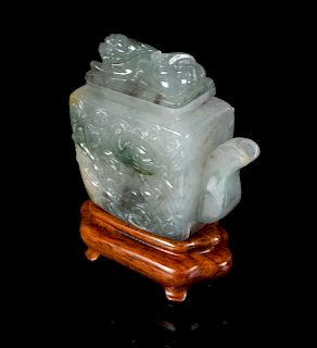 A Chinese Green and White Jadeite Teapot
Height 3 in., 8 cm.