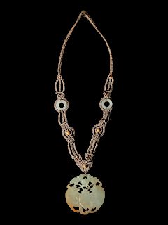 A Chinese Light Russet and Celadon Jade Pendant
Pendant: diam 2 1/4 in., 6 cm. 