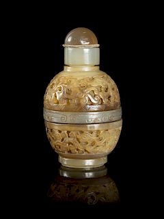 A Chinese Carved Celadon Jade Snuff Bottle
Height 3 in., 8 cm. 