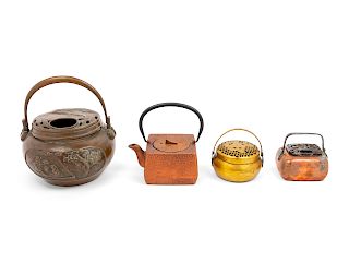 Four Chinese Hand Warmers and Teapot
Largest: diam 7 1/4 in., 18 cm. 