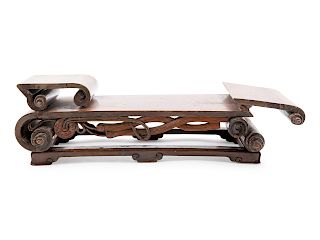 A Chinese Hardwood Scroll-Form Stand
Length 18 1/2 in., 47 cm. 