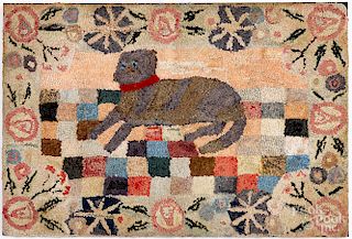Large hooked rug of a recumbent dog