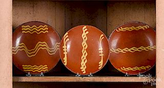 Three Pennsylvania redware plates