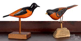 Two carved and painted Baltimore Oriole songbirds