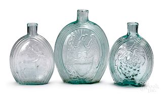 Three pale aqua historical glass flasks
