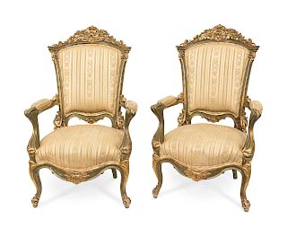 A Pair of Venetian Carved Parcel Gilt Armchairs