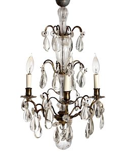 A Louis XV Style Gilt Metal and Crystal Four-Light Chandelier
EARLY 20TH CENTURY
Height 23 x diameter 13 1/2 inches.