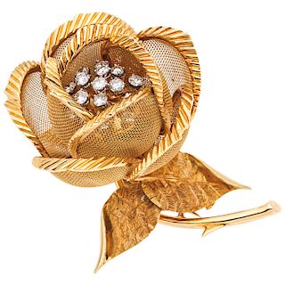 A diamond 18K yellow gold brooch.