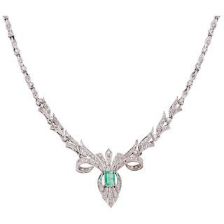 An emerald and diamond palladium silver necklace.