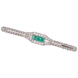 An emerald and diamond 14K white gold brooch.
