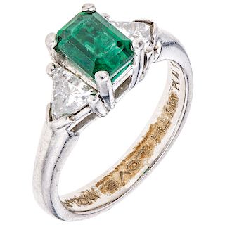 An emerald and diamond platinum ring. 