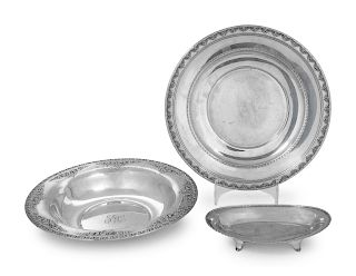 A Group of Three American Silver Serving Articles
Reed & Barton, Mfg. Co., and Wallace Mfg. Co.
comprising two round platters and a small dish.