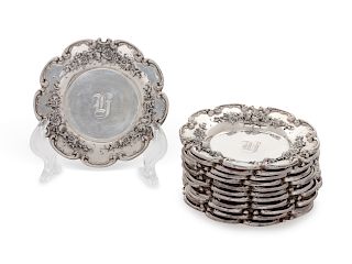 A Set of Twelve American Silver Butter Pats
Redlich & Co., New York, NY
each with floral decoration, monogrammed.
